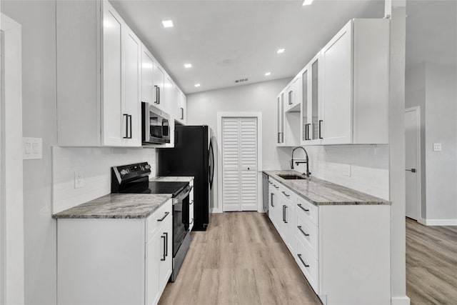 2308 Foxcroft Ln, Arlington, TX 76014 - kitchen featuring electric range, stainless steel microwave, a sink, tasteful backsplash, and light wood-style floors