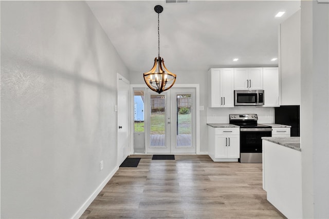2308 Foxcroft Ln, Arlington, TX 76014 - kitchen featuring appliances with stainless steel finishes, a chandelier, white cabinetry, recessed lighting, and light stone counters