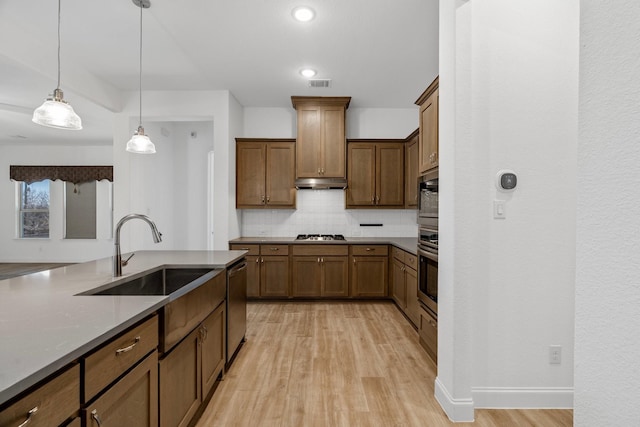 2213 Windy Hill Ln, Waxahachie, TX 75167 - kitchen with a sink, stainless steel appliances, backsplash, light wood-style floors, and pendant lighting