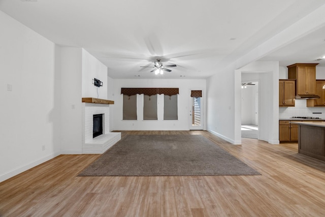2213 Windy Hill Ln, Waxahachie, TX 75167 - unfurnished living room with ceiling fan, light wood finished floors, baseboards, and a brick fireplace