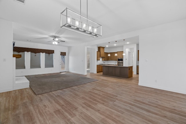 2213 Windy Hill Ln, Waxahachie, TX 75167 - unfurnished living room with light wood-type flooring, baseboards, and ceiling fan