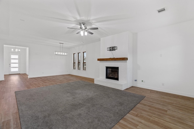 2213 Windy Hill Ln, Waxahachie, TX 75167 - unfurnished living room featuring a ceiling fan, wood finished floors, a fireplace, and baseboards