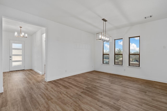 2213 Windy Hill Ln, Waxahachie, TX 75167 - unfurnished room featuring a chandelier, wood finished floors, and baseboards