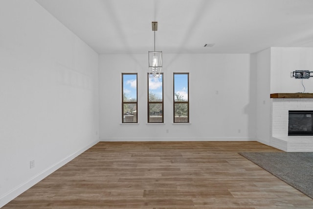 2213 Windy Hill Ln, Waxahachie, TX 75167 - unfurnished dining area featuring wood finished floors, a fireplace, and baseboards