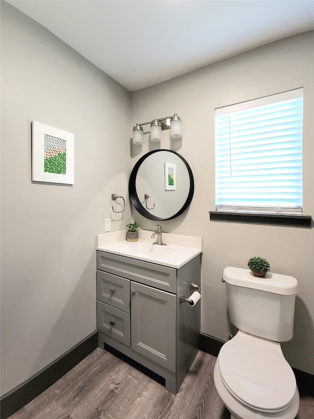9306 High Noon Dr, Wylie, TX 75098 - half bathroom with wood finished floors, vanity, toilet, and baseboards