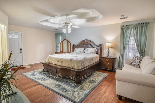 8887 Random Rd, Fort Worth, TX 76179 - bedroom featuring a raised ceiling, wood finished floors, a ceiling fan, and baseboards