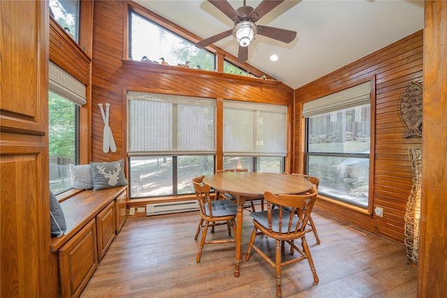 203 King Laurence, Scroggins, TX 75480 - dining area with a baseboard radiator, lofted ceiling, wooden walls, light wood-style flooring, and a ceiling fan