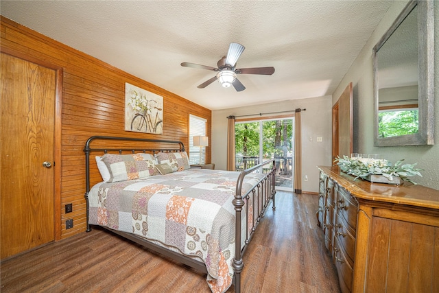 203 King Laurence, Scroggins, TX 75480 - bedroom with access to exterior, wood finished floors, wooden walls, ceiling fan, and baseboards