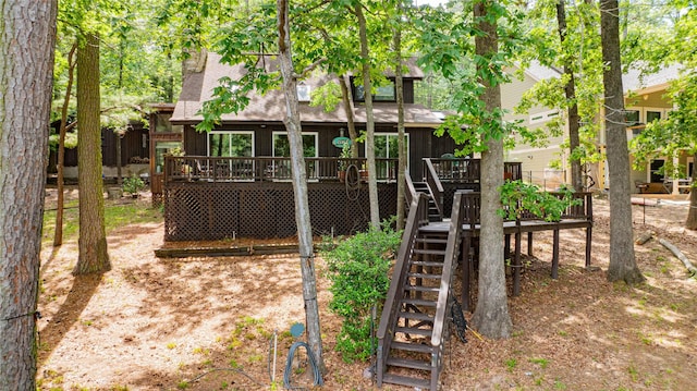 203 King Laurence, Scroggins, TX 75480 - rear view of house featuring stairway, a deck, and board and batten siding