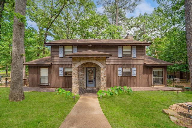 203 King Laurence, Scroggins, TX 75480 - view of front of home featuring a chimney, a front yard, and a deck