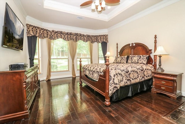 2221 Southern Oaks Dr, Cedar Hill, TX 75104 - bedroom featuring dark wood finished floors, ornamental molding, a raised ceiling, a ceiling fan, and baseboards