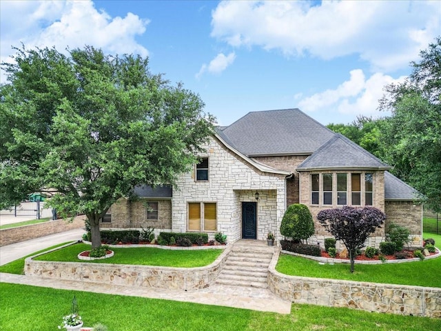 2221 Southern Oaks Dr, Cedar Hill, TX 75104 - french provincial home with stone siding, a front lawn, and roof with shingles