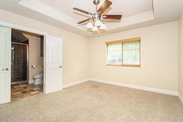 2221 Southern Oaks Dr, Cedar Hill, TX 75104 - unfurnished bedroom featuring a raised ceiling, carpet flooring, baseboards, and connected bathroom