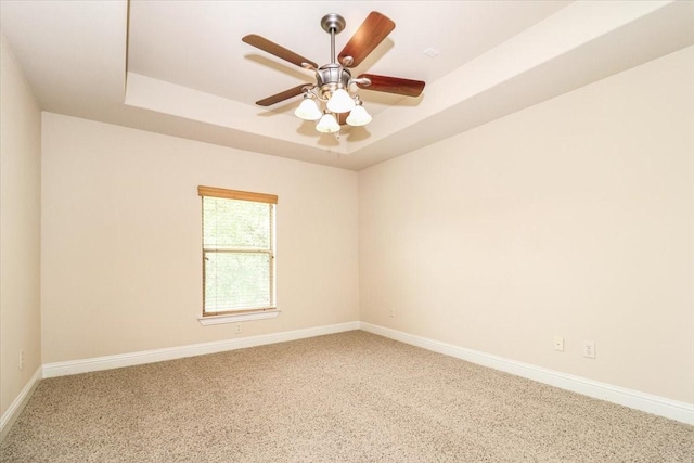 2221 Southern Oaks Dr, Cedar Hill, TX 75104 - spare room featuring a tray ceiling, baseboards, carpet, and ceiling fan