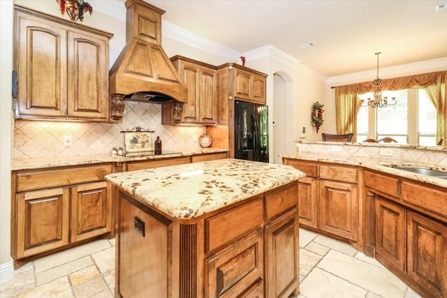 2221 Southern Oaks Dr, Cedar Hill, TX 75104 - kitchen with black appliances, custom range hood, stone tile floors, light stone countertops, and a center island