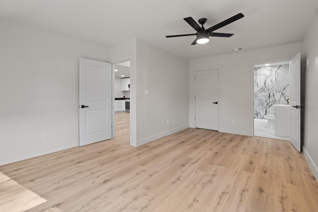 3009 Ave H, Fort Worth, TX 76105 - unfurnished bedroom featuring light wood finished floors, baseboards, ensuite bath, and a ceiling fan