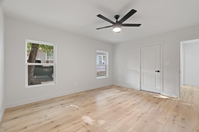 3009 Ave H, Fort Worth, TX 76105 - unfurnished bedroom featuring multiple windows, light wood-style floors, and baseboards