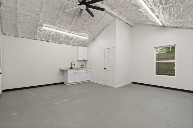 3009 Ave H, Fort Worth, TX 76105 - spare room featuring concrete floors, a sink, lofted ceiling, a ceiling fan, and baseboards