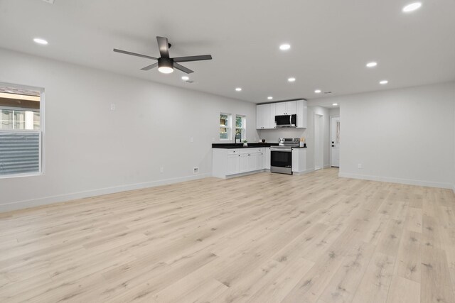 3009 Ave H, Fort Worth, TX 76105 - unfurnished living room with light wood-style floors, recessed lighting, baseboards, and ceiling fan