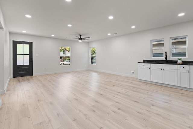 3009 Ave H, Fort Worth, TX 76105 - unfurnished living room featuring a sink, a ceiling fan, light wood-style floors, recessed lighting, and baseboards