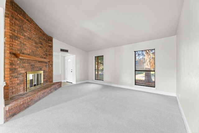 600 Via Del Sur Spur, Mesquite, TX 75150 - unfurnished living room featuring carpet flooring, vaulted ceiling, a brick fireplace, and baseboards