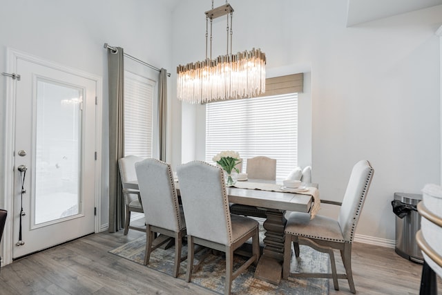 2702 Willow Ln, Melissa, TX 75454 - dining room featuring a chandelier, wood finished floors, healthy amount of natural light, and a high ceiling