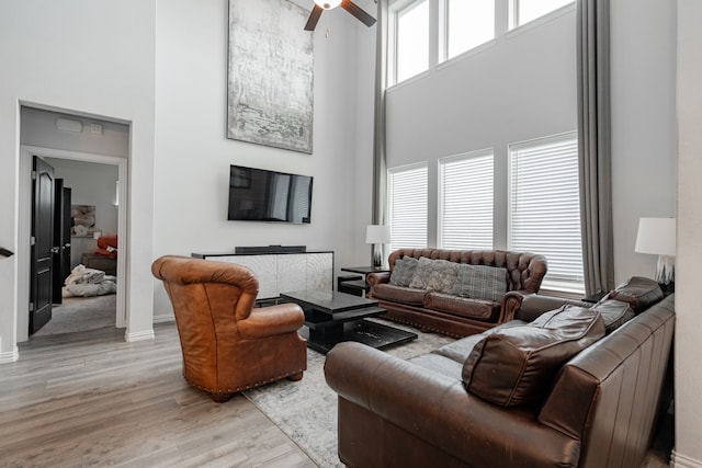 2702 Willow Ln, Melissa, TX 75454 - living area with a high ceiling, light wood-type flooring, a ceiling fan, and baseboards