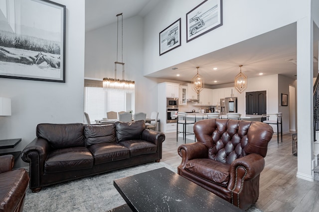 2702 Willow Ln, Melissa, TX 75454 - living room with a chandelier, high vaulted ceiling, light wood-type flooring, recessed lighting, and baseboards