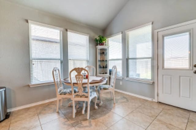 11520 Starlight Ranch Trl, Fort Worth, TX 76052 - dining room with lofted ceiling, light tile patterned floors, and baseboards