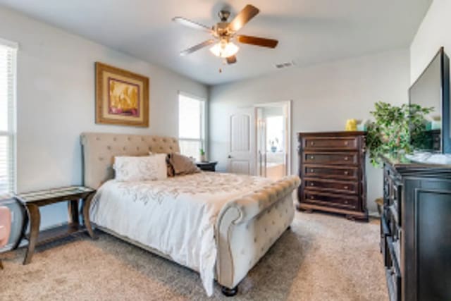 11520 Starlight Ranch Trl, Fort Worth, TX 76052 - bedroom with light carpet, ensuite bathroom, and ceiling fan