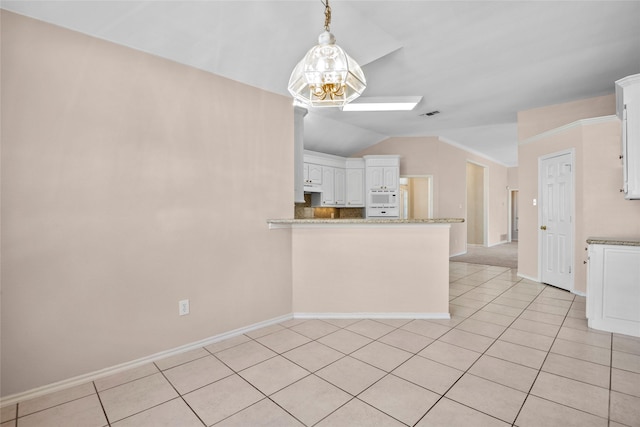 6705 Rolling Hills Dr, North Richland Hills, TX 76182 - kitchen with lofted ceiling, white cabinets, a peninsula, light tile patterned flooring, and baseboards
