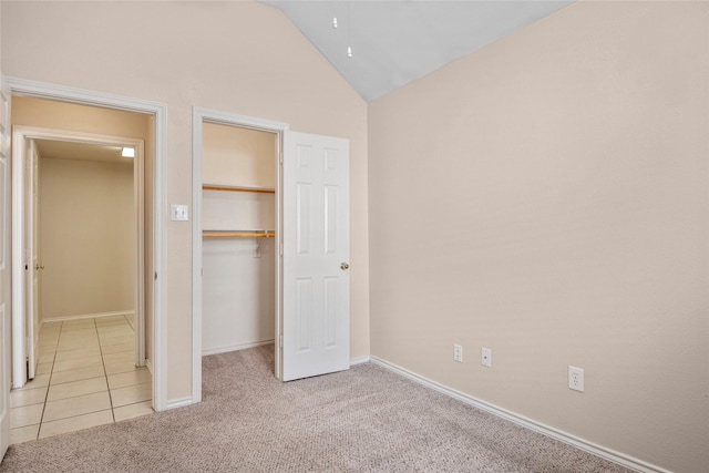 6705 Rolling Hills Dr, North Richland Hills, TX 76182 - unfurnished bedroom with a walk in closet, vaulted ceiling, light colored carpet, a closet, and baseboards