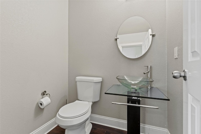 313 Wallford Ln, Lake Dallas, TX 75065 - half bathroom featuring a sink, baseboards, toilet, and wood finished floors