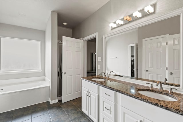 313 Wallford Ln, Lake Dallas, TX 75065 - full bath featuring double vanity, a bath, baseboards, and tile patterned floors