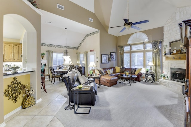 2724 Ferncrest Trl, Mansfield, TX 76063 - living room with ceiling fan, high vaulted ceiling, a stone fireplace, arched walkways, and baseboards