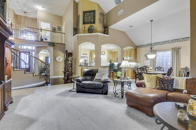 2724 Ferncrest Trl, Mansfield, TX 76063 - living area featuring high vaulted ceiling, arched walkways, stairs, baseboards, and carpet