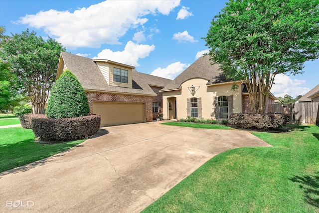 9961 Loveland Ct, Shreveport, LA 71106 - french provincial home featuring brick siding, driveway, a shingled roof, and an attached garage