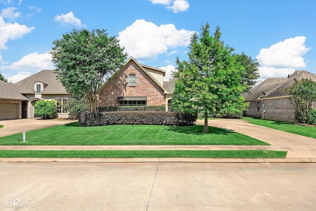 9961 Loveland Ct, Shreveport, LA 71106 - view of front of home with brick siding, a front yard, and driveway