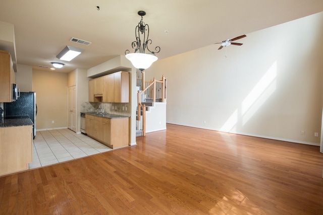 6624 Federal Hall St, Plano, TX 75023 - kitchen with light brown cabinetry, a sink, ceiling fan, decorative backsplash, and light wood finished floors