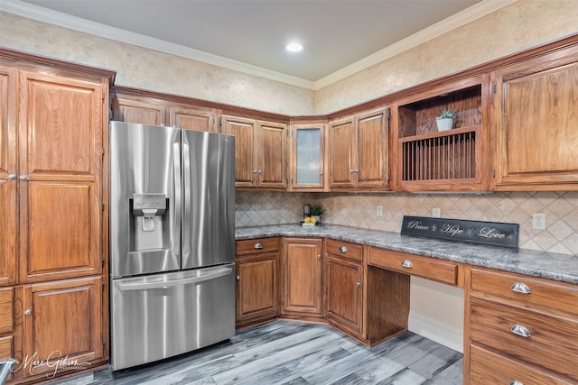 1321 Anniston Ave, Shreveport, LA 71105 - kitchen with stainless steel fridge, brown cabinetry, ornamental molding, light wood-style floors, and decorative backsplash