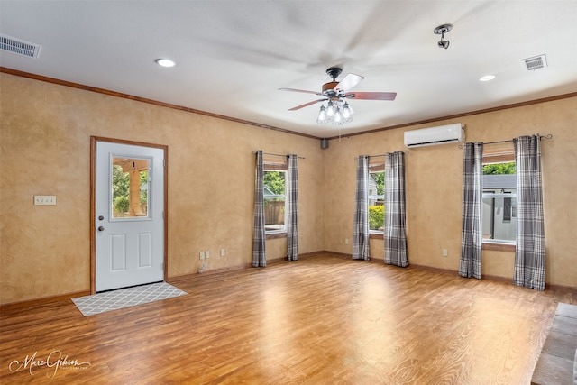 1321 Anniston Ave, Shreveport, LA 71105 - spare room featuring a wall unit AC, wood finished floors, plenty of natural light, and crown molding