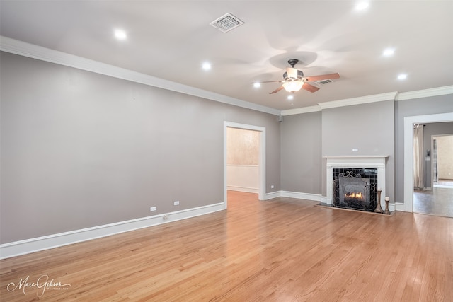 1321 Anniston Ave, Shreveport, LA 71105 - unfurnished living room featuring ceiling fan, ornamental molding, recessed lighting, a lit fireplace, and light wood finished floors