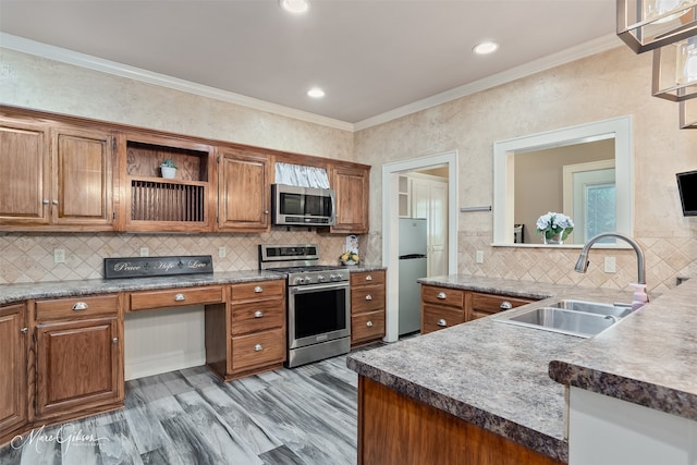 1321 Anniston Ave, Shreveport, LA 71105 - kitchen featuring appliances with stainless steel finishes, a sink, brown cabinetry, crown molding, and recessed lighting