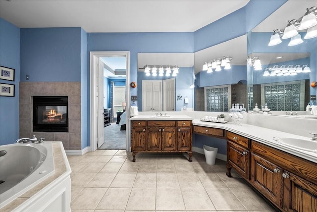 1304 Salsbury Cir, Murphy, TX 75094 - bathroom with a jetted tub, tile patterned flooring, vanity, a fireplace, and ensuite bathroom