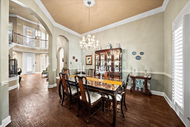 1304 Salsbury Cir, Murphy, TX 75094 - dining room featuring arched walkways, a chandelier, a high ceiling, wood finished floors, and crown molding