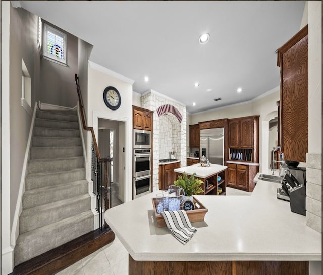 1304 Salsbury Cir, Murphy, TX 75094 - kitchen with built in appliances, ornamental molding, light countertops, a kitchen island, and a peninsula