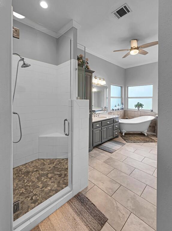 804 Heritage Pkwy, Axtell, TX 76624 - bathroom with crown molding, a stall shower, a freestanding bath, vanity, and a ceiling fan