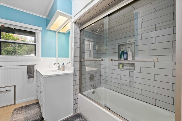 2202 Belmeade Ave, Brownwood, TX 76801 - bathroom featuring vanity, crown molding, bath / shower combo with glass door, and a wainscoted wall