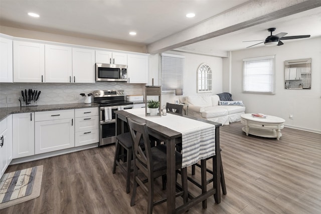 1814 Stacy Rd, Fairview, TX 75069 - kitchen with stainless steel appliances, dark wood finished floors, decorative backsplash, white cabinets, and recessed lighting
