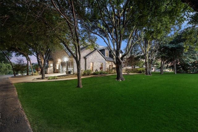 1814 Stacy Rd, Fairview, TX 75069 - view of front facade featuring stone siding, a front lawn, a standing seam roof, and metal roof